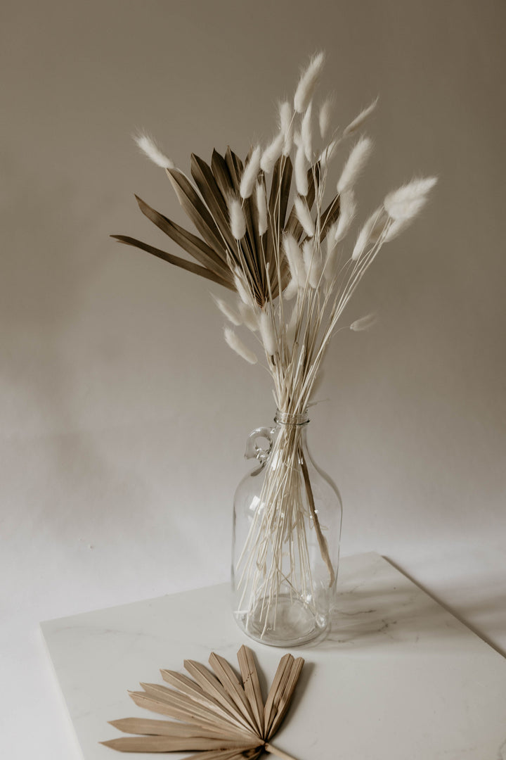 Natural sun palms with bunny tails in clear jug vase from By Two Fields