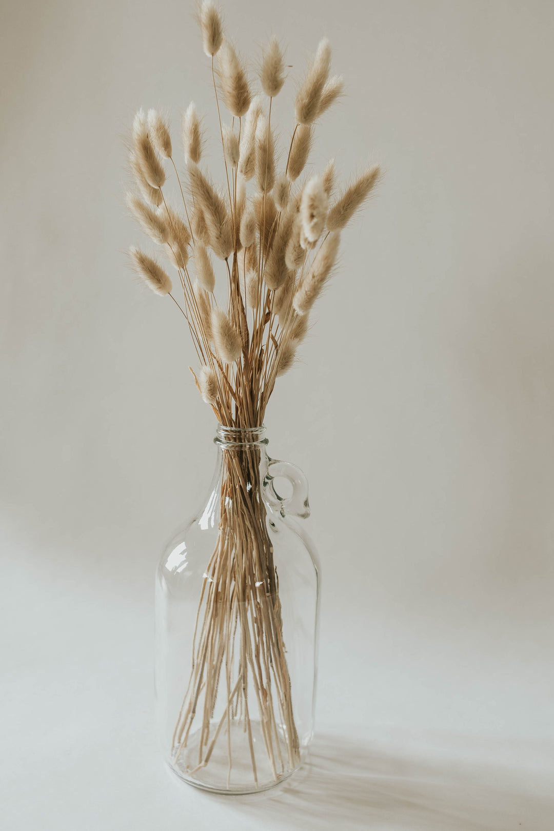 Natural bunny tails in clear jug vase for By Two Fields