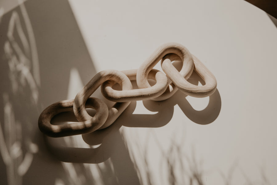 Close up of natural wood chain links for By Two Fields